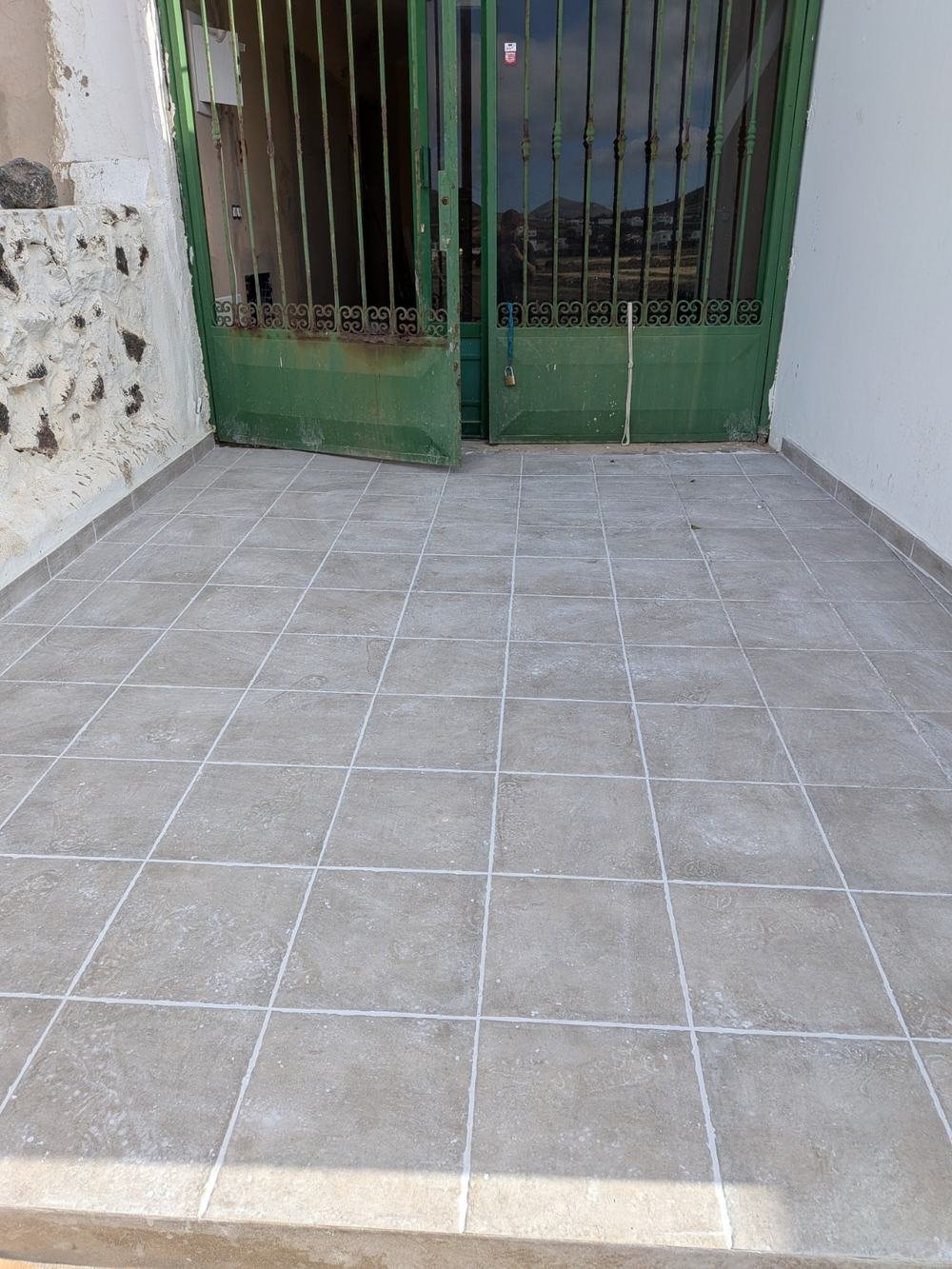 Patio terminado en Tinajo con el pavimento cerámico colocado y rejuntado